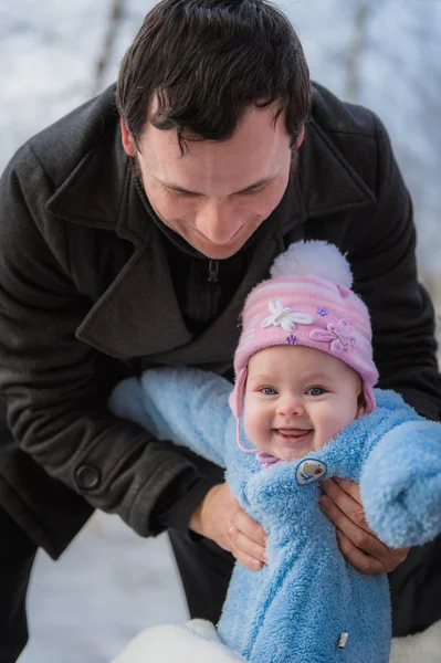 Smiling baby on father hands. Happy infant girl while Hiking in winter — Stock Photo, Image