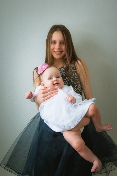 Beautiful young mother and her cute daughter in white dress — Stock Photo, Image