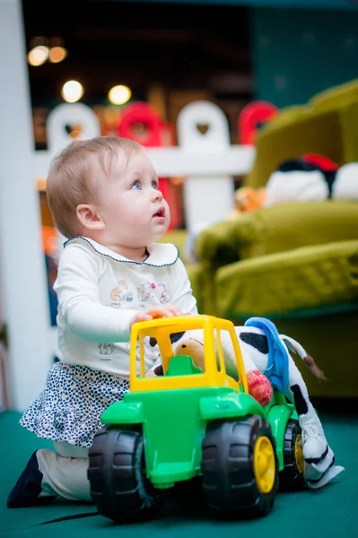 Adorable baby plays with car on floor at home. — 图库照片