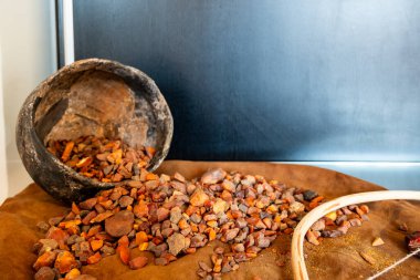 an assortment of precious amber gemstones pouring out of a bucket