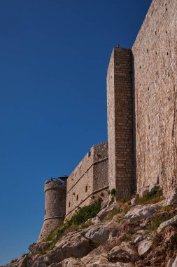 Hırvatistan 'ın Dubrovnik kentindeki uçurumlardaki Büyük Taş Duvarlar ve Yuvarlak Kule Dikey Görünümü