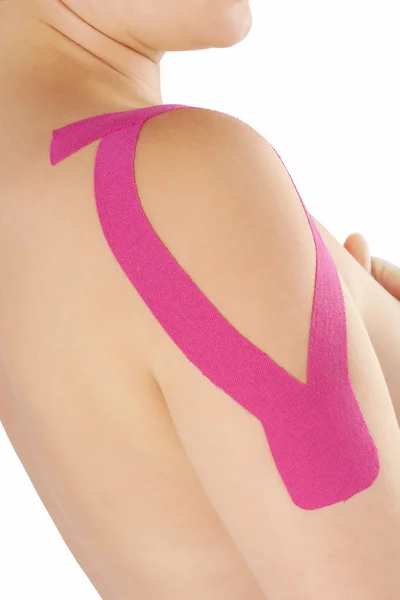 Therapeutic tape on female shoulder. — Stock Photo, Image