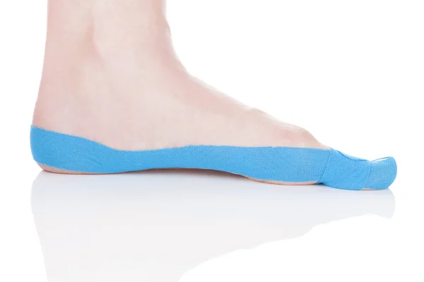 Therapeutic tape on female foot. — Stock Photo, Image