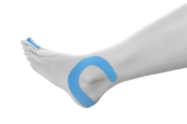 Therapeutic tape on female ankle. — Stock Photo, Image
