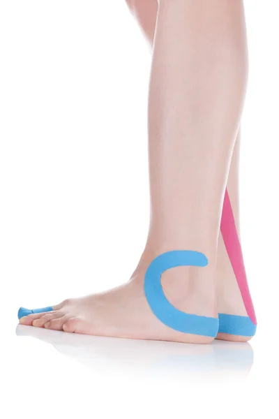 Therapeutic tape on female foot. — Stock Photo, Image