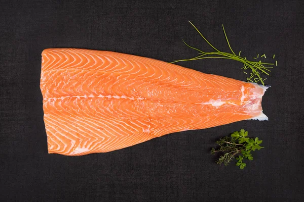 Salmon meat on black background. — Stock Photo, Image