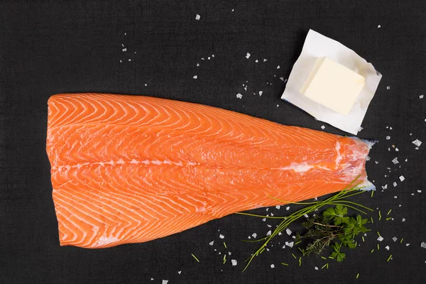 Salmon meat on black background. — Stock Photo, Image