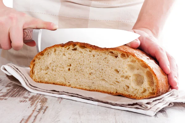 Baker memotong roti segar yang dibuat . — Stok Foto