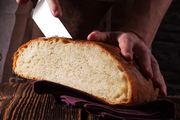Baker holding fresh made bread. — Stock Photo, Image