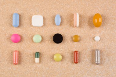 Various colorful pills, capsules and tablets, flat lay. Vitamins, perscription drugs, painkillers, nutritional supplements and antidepressants. Big Pharma. clipart