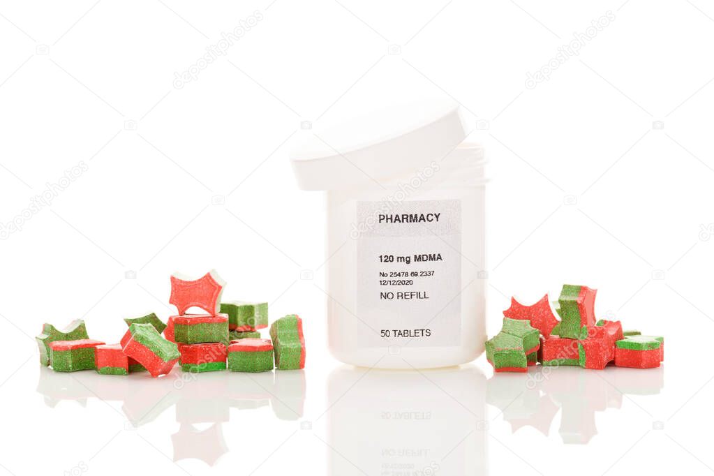 Ecstasy pills in perscription bottle isolated on white background. MDMA-Assisted Psychotherapy for PTSD.