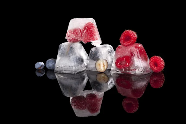 Berries frozen in ice cubes. — Stock Photo, Image