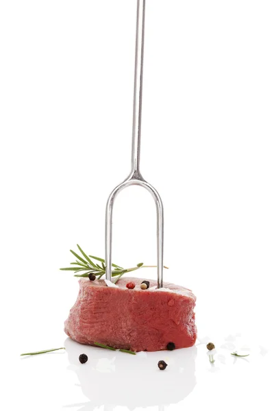 Raw steak on fork. — Stock Photo, Image