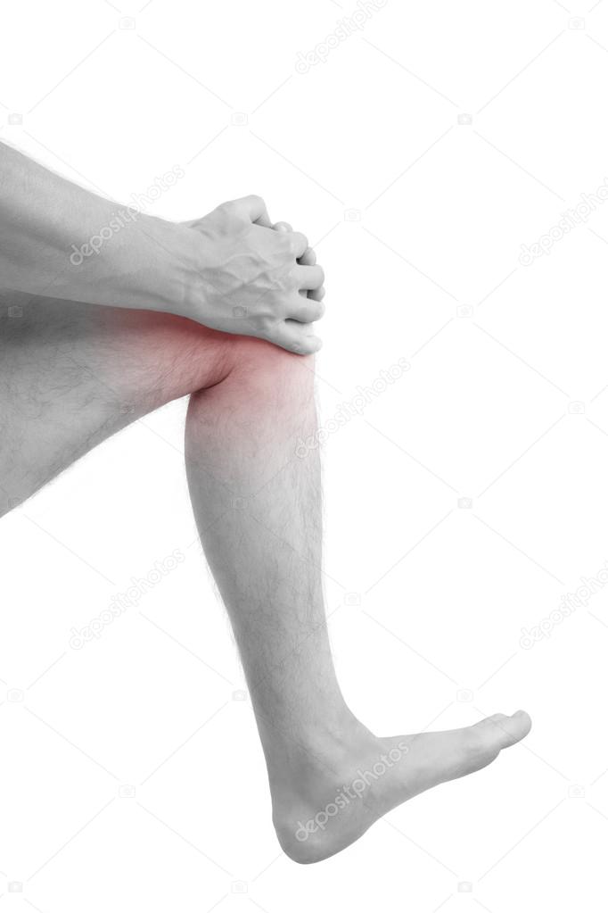 Man holding injured knee.