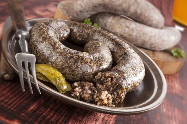 Blood sausage and rice sausage on wooden background. — Stock Photo, Image