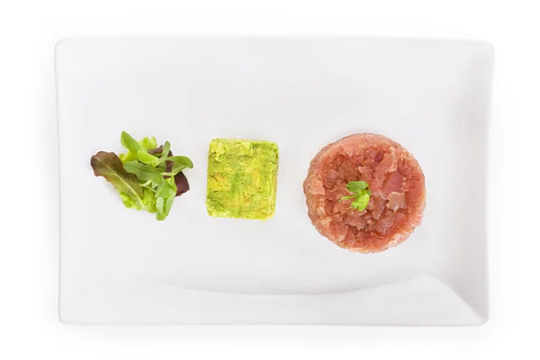 Salmon tartare with salad and avocado. — Stock Photo, Image