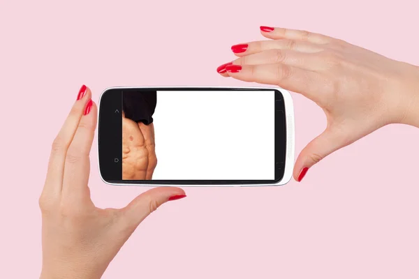 Mãos femininas segurando smartphone com foto de homem bonito — Fotografia de Stock