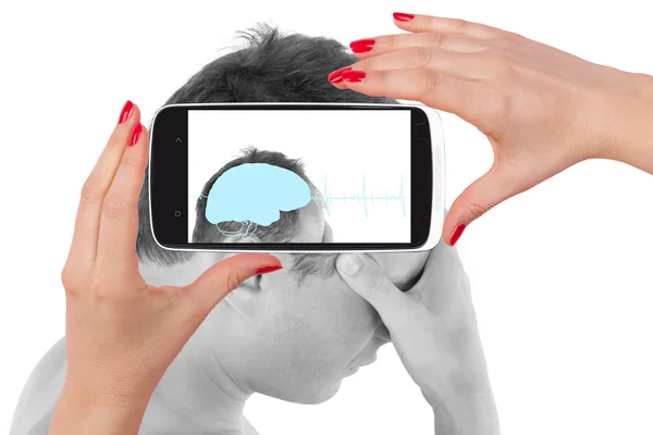 Man touching his head and seeing the diagnosis on a smartphone — Stock Photo, Image