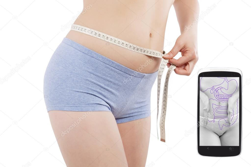 girl measuring her waist with tape measure