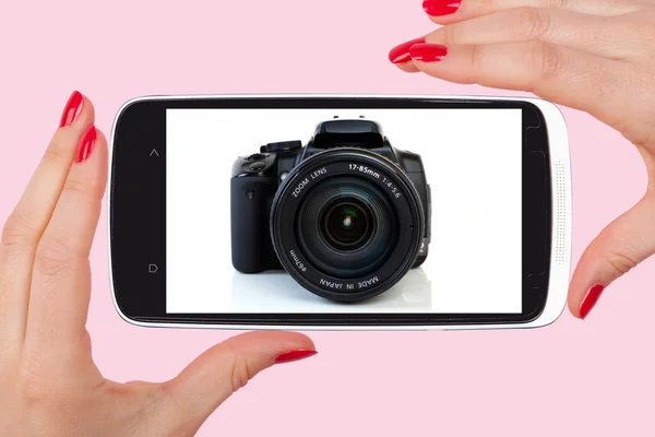 Female hand with red nails holding smartphone — Stok fotoğraf