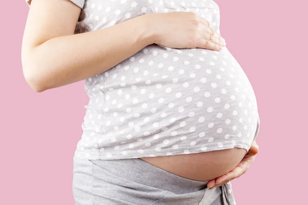 Pregnant belly over pink background. — Stock Photo, Image