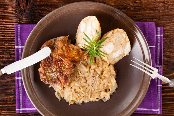 Baked pork chop with dumplings and sauerkraut — Stock Photo, Image