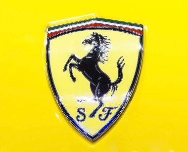 logo of Ferrari on yellow super sport car 