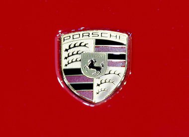 logo of Porsche on red texture