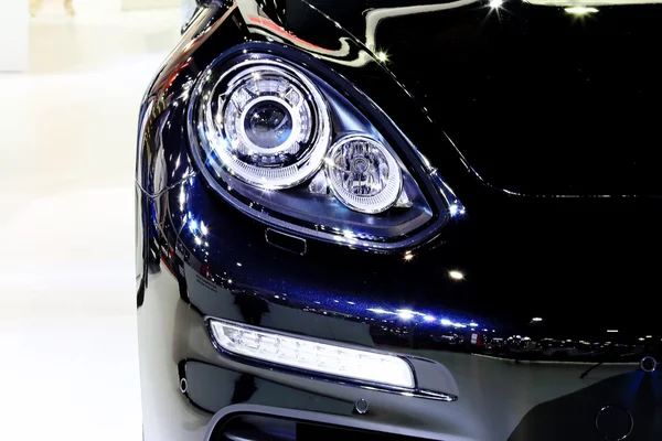 Headlight of blue Porsche series Panamera Se hybrid luxury sport — Stockfoto
