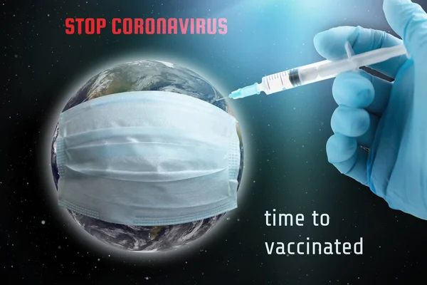 Coronavirus global vaccination concept. Earth in a protective mask, hand with a syringe makes an injection. Earth image courtesy of NASA