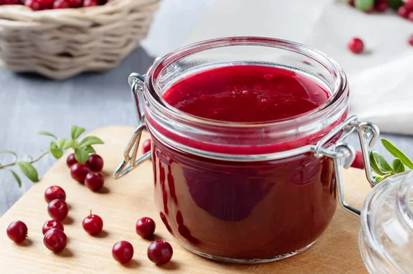 Glass jar with homemade lingonberry sauce. Canning lingonberry sauce — Stock Photo, Image