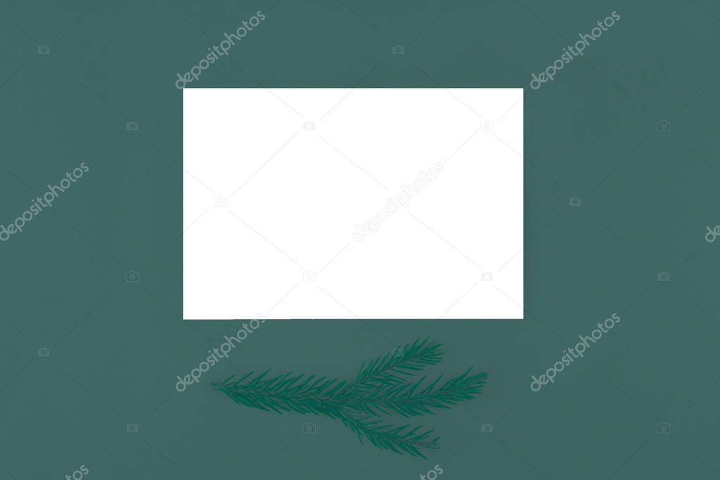 Christmas card mock up. New Year greetings letter. Festive winter composition with empty blank with copy space for text, branch of Christmas tree on tidewater green background, color of year 2021