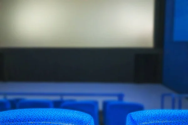 Cinema hall with empty screen and Blue seats (armchairs)