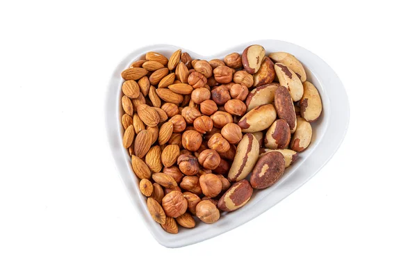 Assortment Various Types Nuts Hazelnuts Almonds Pecan Heart Shaped Plate — Stock Photo, Image