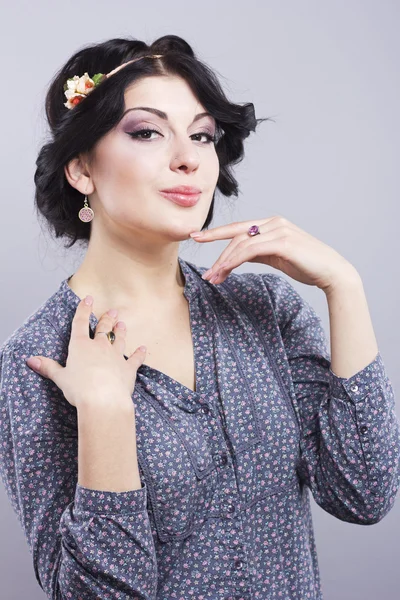 Beautiful brunette on a gray background.Eyelash extensions. Lip augmentation. nail extension — Stock Photo, Image