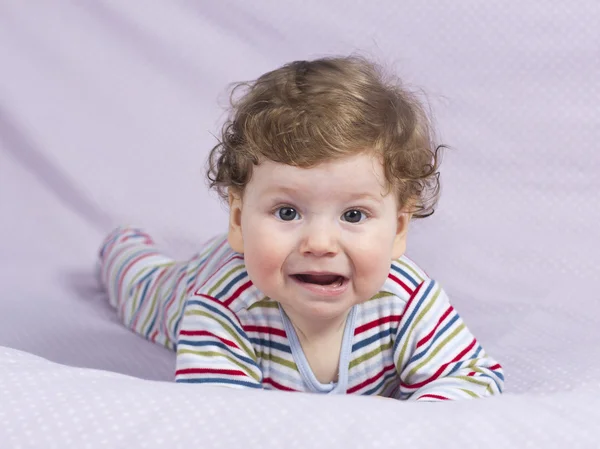 Beautiful baby with a lovely toy. The child in the crib. — Stock Photo, Image