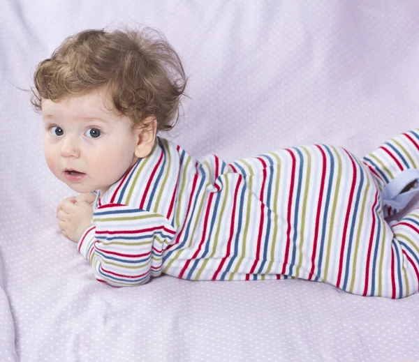 Beautiful baby with a lovely toy. The child in the crib. — Stock Photo, Image