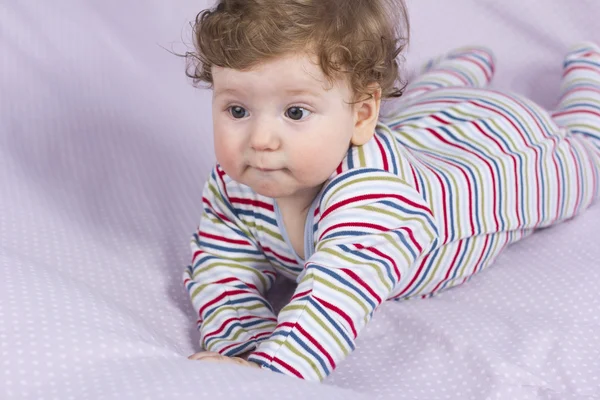 Beautiful baby with a lovely toy. The child in the crib. — Stock Photo, Image