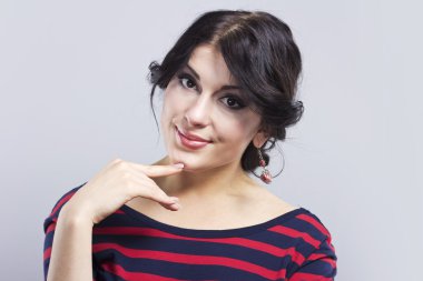 Çizgili bir elbise güzel kız. Siyah bir zemin üzerine esmer gülümseyen. Akıllı kadın portresi