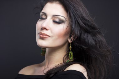 Güzel esmer ile uçan bir saç. Takı güzel bir kızın portresi. Parlak saçlar. Moda. Güzel kadın süsler