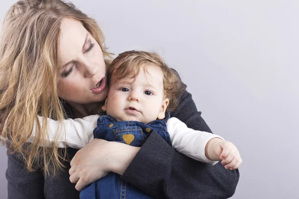 Beautiful blonde with her little son on hands. Happy business woman. Family life. Children. Young mother — Stock Photo, Image