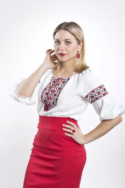 Mujer rubia joven con camisa bordada ucraniana. Hermosa chica en una blusa y falda roja —  Fotos de Stock