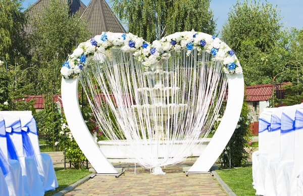 Wedding arch outdoors. Natural flowers. Decor. Floristics. visiting ceremony