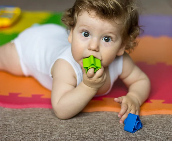 The child is one year old with toys. Gifts for baby. — Stock Photo, Image