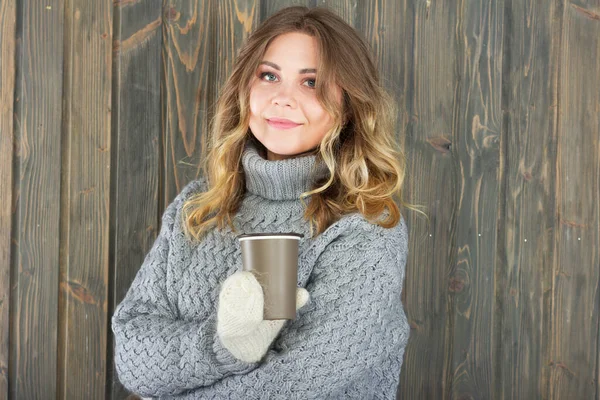 Smiling woman with a cup of hot tea
