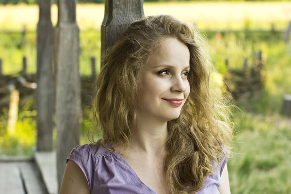 Beautiful curly blonde with red lips. Portrait outdoors. Face of a beautiful young girl — Stock Photo, Image