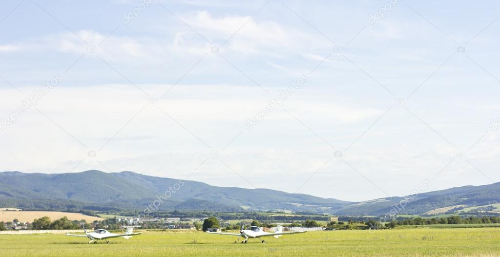 Beautiful mountain landscape with a small plane in the background. Plane by a single pilot. steppe