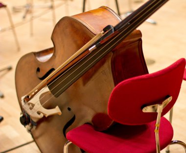 Contrabass on stage in front of an empty hall clipart