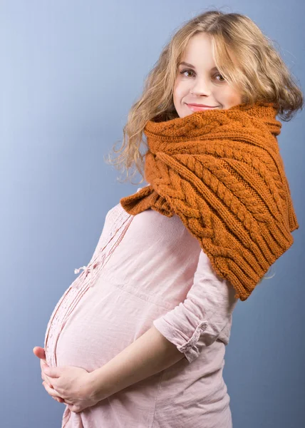 Красивая беременная блондинка в тёплом коричневом шарфе. Портрет молодой беременной женщины — стоковое фото