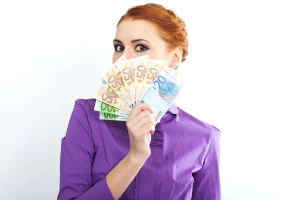 Young red-haired girl with euro banknotes. Portrait of slim girl in a bright shirt — Stock Photo, Image